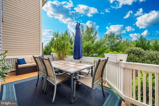 wooden deck featuring outdoor dining space