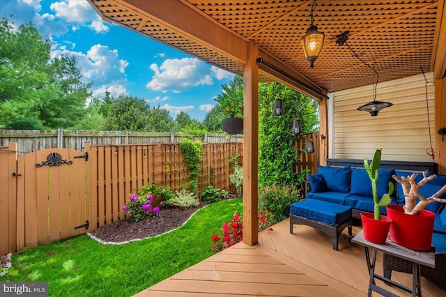 wooden deck featuring fence, an outdoor living space, and a gate