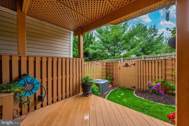 wooden deck with fence and cooling unit
