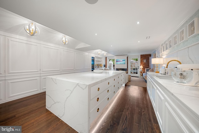 109 Duke St, Alexandria, VA 22314 - kitchen featuring white cabinetry, open floor plan, dark wood-style floors, and a kitchen island