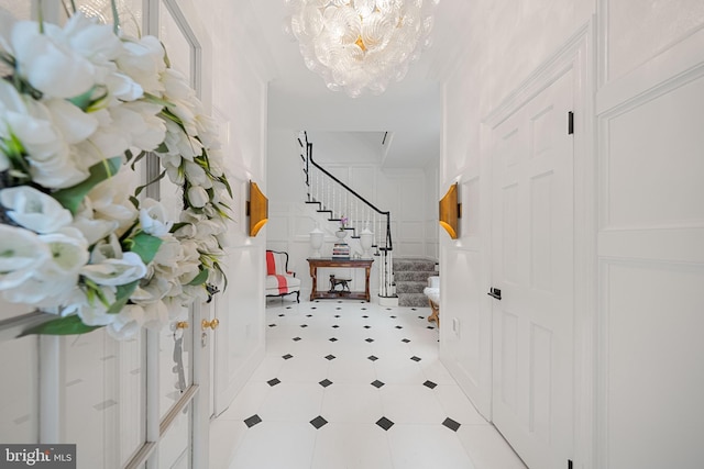 109 Duke St, Alexandria, VA 22314 - entryway with stairs, a chandelier, light flooring, and a decorative wall
