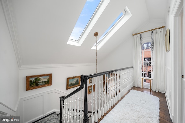 109 Duke St, Alexandria, VA 22314 - corridor with a skylight, an upstairs landing, vaulted ceiling, ornamental molding, and wood finished floors