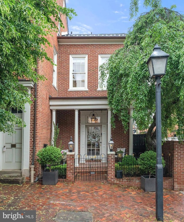 109 Duke St, Alexandria, VA 22314 - view of front of home with brick siding and a porch