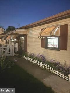 view of property exterior featuring fence