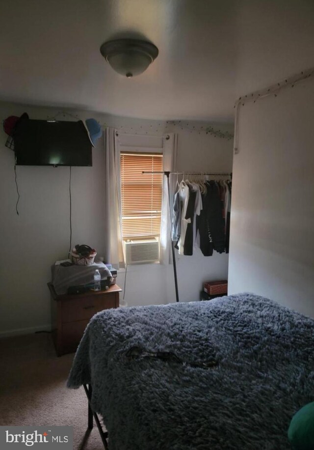 bedroom featuring carpet flooring and cooling unit