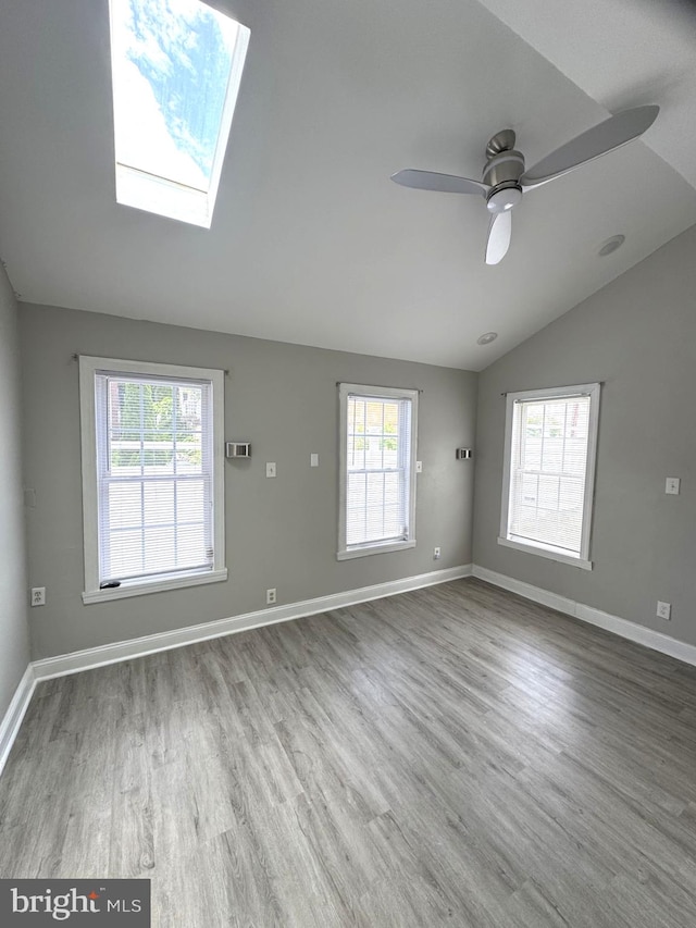 2117 Kearny St NE, Washington, DC 20018 - empty room with vaulted ceiling, wood finished floors, baseboards, and a ceiling fan