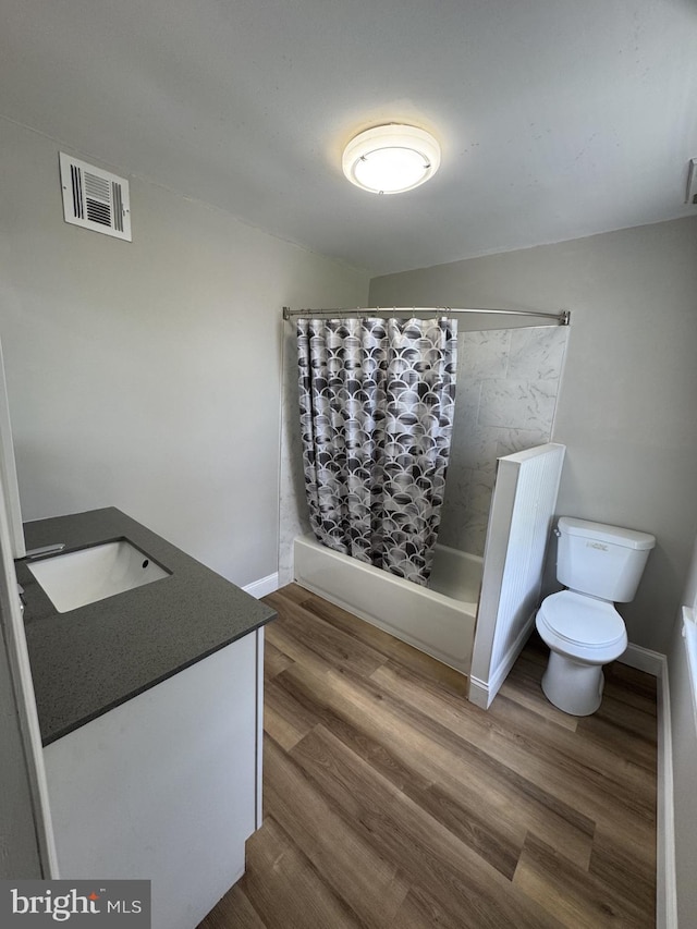 2117 Kearny St NE, Washington, DC 20018 - full bathroom featuring toilet, vanity, shower / bath combination with curtain, and wood finished floors