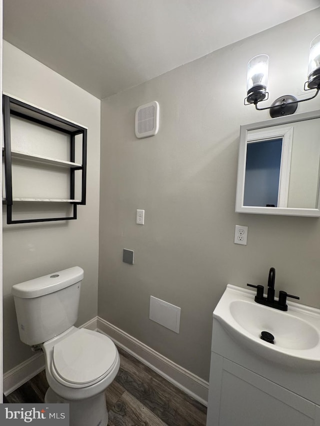 2117 Kearny St NE, Washington, DC 20018 - bathroom featuring wood finished floors, vanity, toilet, and baseboards