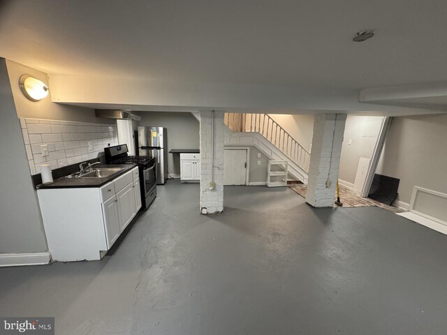 2117 Kearny St NE, Washington, DC 20018 - kitchen with appliances with stainless steel finishes, dark countertops, finished concrete floors, decorative backsplash, and white cabinetry