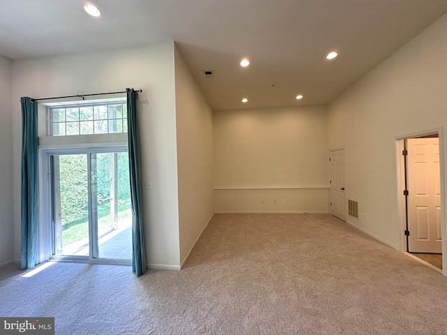 carpeted empty room featuring recessed lighting and baseboards