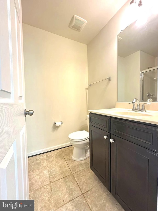 full bathroom featuring a shower stall, toilet, tile patterned floors, vanity, and baseboards