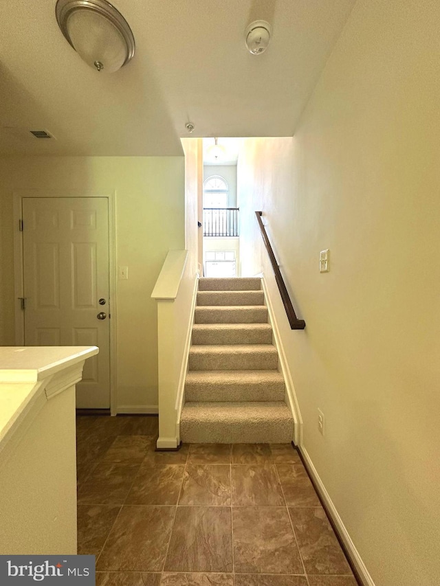 staircase featuring baseboards