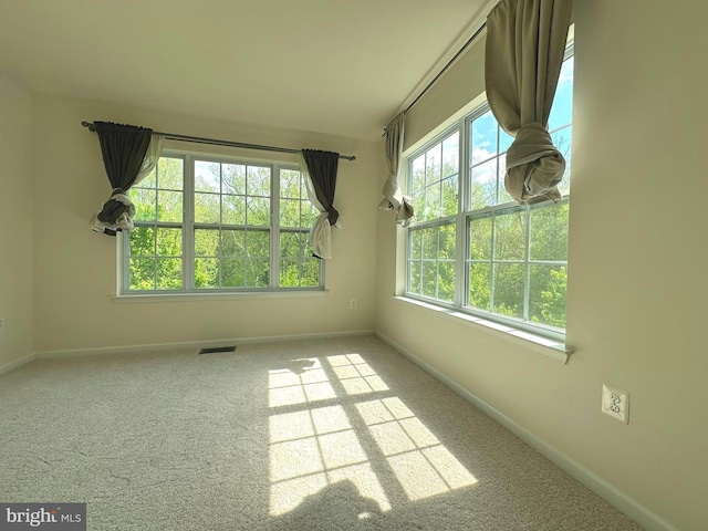 unfurnished room with baseboards and carpet