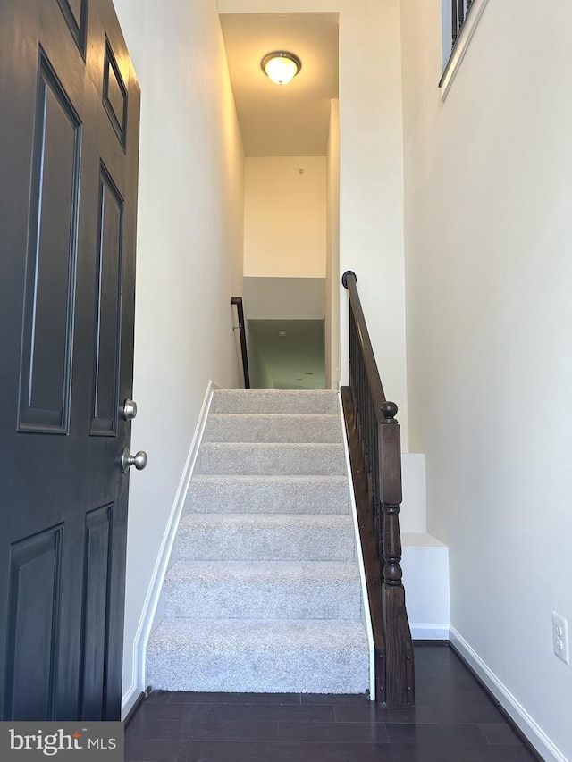stairs featuring baseboards and wood finished floors