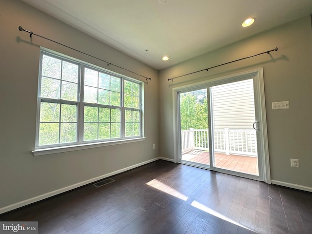 spare room featuring baseboards, dark wood-style flooring, and recessed lighting