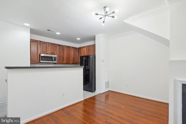 24764 Stone Station Ter, Aldie, VA 20105 - kitchen with stainless steel microwave, freestanding refrigerator, a chandelier, recessed lighting, and dark countertops