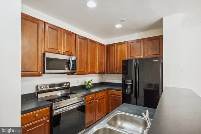 24764 Stone Station Ter, Aldie, VA 20105 - kitchen featuring stainless steel appliances, dark countertops, recessed lighting, a sink, and brown cabinets