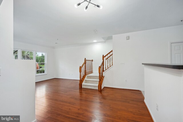 24764 Stone Station Ter, Aldie, VA 20105 - unfurnished room with stairway, a chandelier, wood finished floors, baseboards, and crown molding
