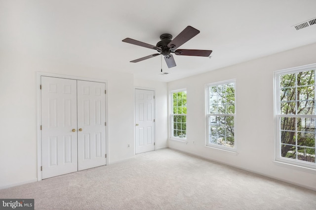 24764 Stone Station Ter, Aldie, VA 20105 - unfurnished bedroom with multiple windows, carpet floors, and multiple closets