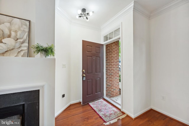 24764 Stone Station Ter, Aldie, VA 20105 - entryway featuring wood finished floors, ornamental molding, baseboards, a chandelier, and a high end fireplace