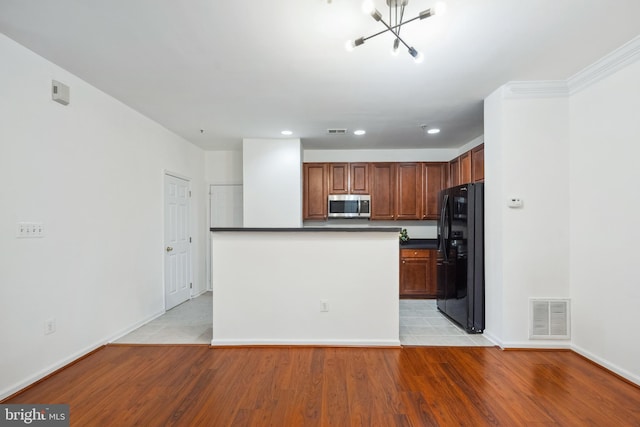 24764 Stone Station Ter, Aldie, VA 20105 - kitchen with stainless steel microwave, freestanding refrigerator, dark countertops, light wood-style flooring, and recessed lighting