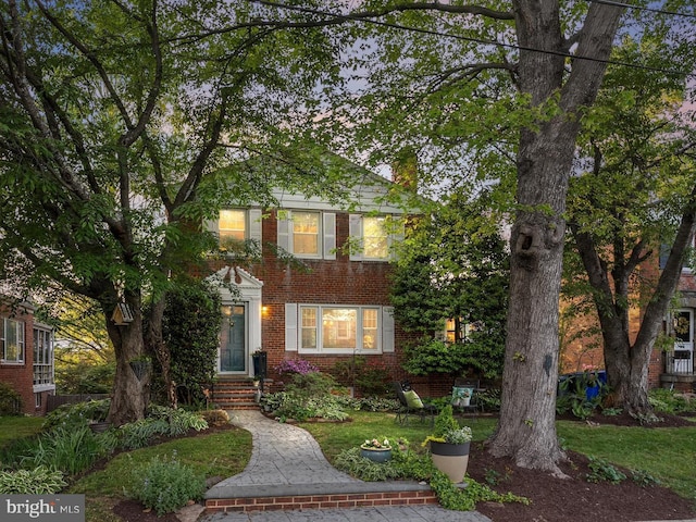 view of front of house featuring brick siding