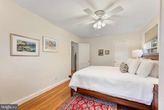 bedroom featuring light wood-type flooring, baseboards, and ceiling fan
