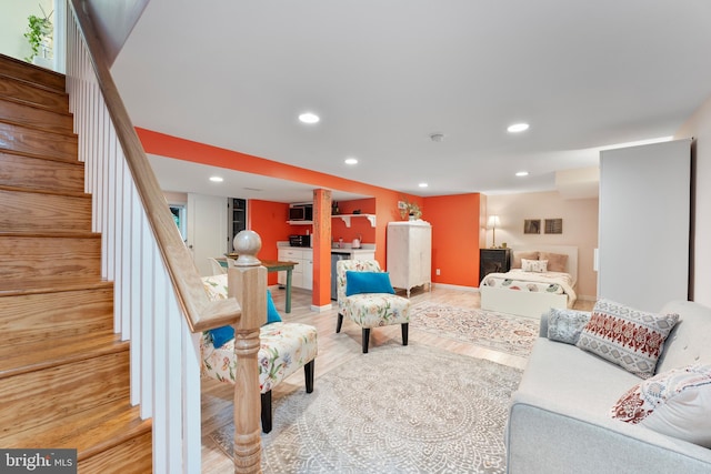 living area with stairs, bar, wood finished floors, recessed lighting, and baseboards