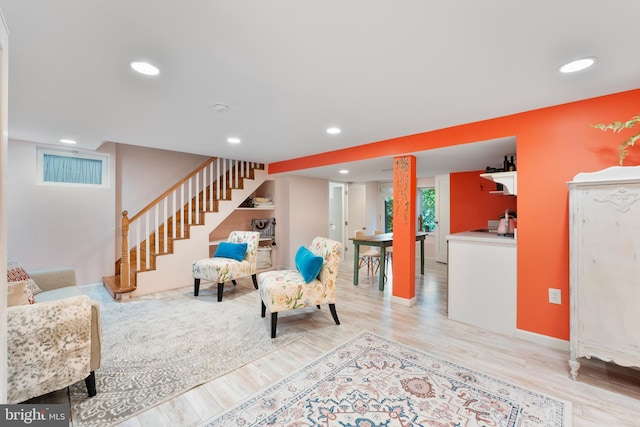 living area with stairway, light wood-style flooring, baseboards, and recessed lighting