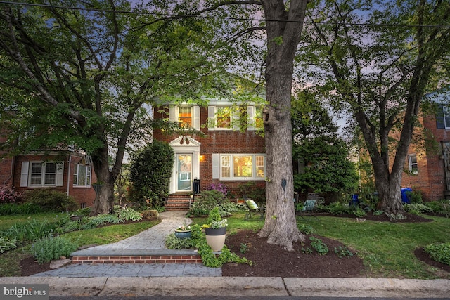 view of front of home featuring brick siding