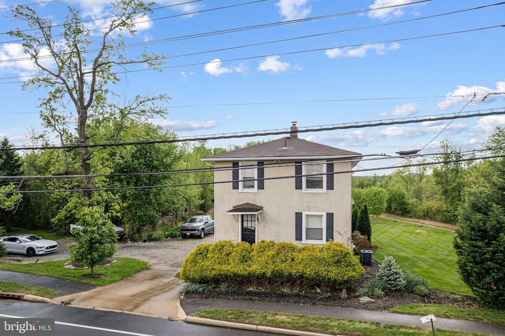 780 Hartford Rd, Moorestown, NJ 08057 - view of front of house with cooling unit, stucco siding, driveway, and a front lawn