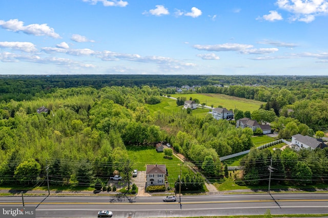 bird's eye view with a wooded view