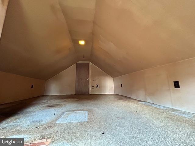 bonus room with carpet floors and lofted ceiling