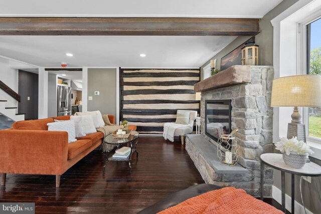 living room with hardwood / wood-style flooring, a healthy amount of sunlight, and stairway
