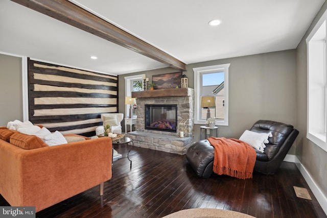 living room with baseboards, a fireplace, and hardwood / wood-style flooring