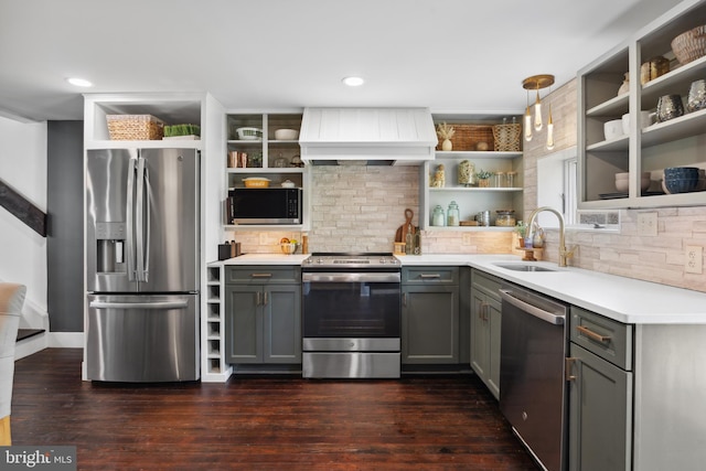 kitchen with a sink, gray cabinetry, open shelves, and stainless steel appliances