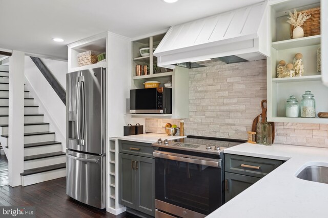 kitchen featuring open shelves, custom exhaust hood, gray cabinetry, and stainless steel appliances