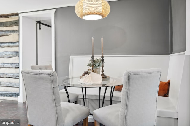 dining space featuring a barn door
