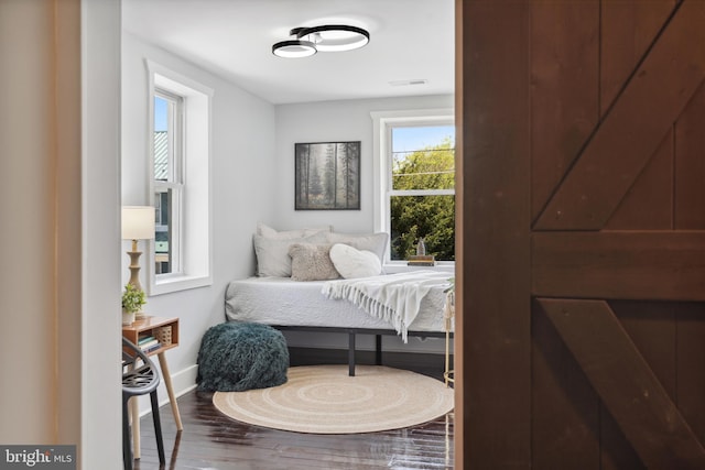 bedroom with baseboards and wood finished floors