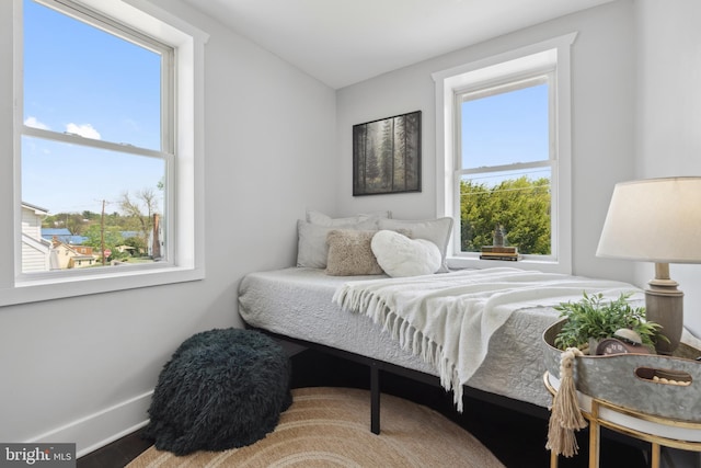 bedroom featuring baseboards and wood finished floors