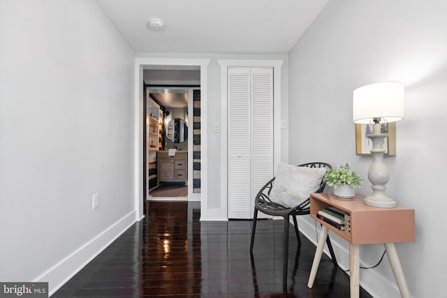 interior space featuring baseboards and wood finished floors