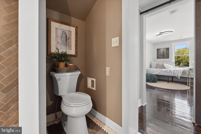 bathroom featuring baseboards, visible vents, toilet, and hardwood / wood-style flooring