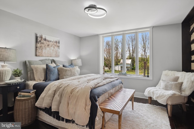 bedroom with baseboards and wood finished floors