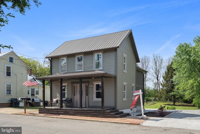 view of front of home featuring covered porch and metal roof