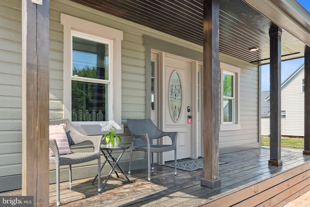 view of exterior entry featuring a porch
