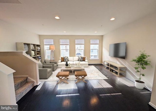 living area featuring stairs, recessed lighting, baseboards, and wood finished floors