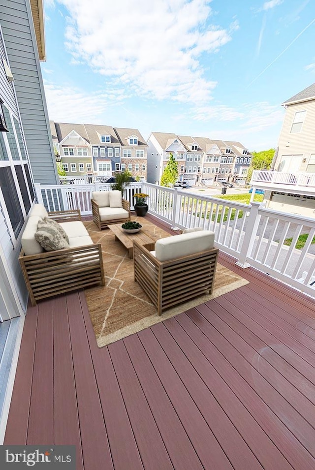 wooden terrace featuring a residential view and an outdoor hangout area