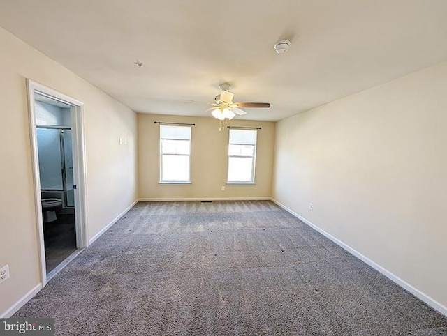 spare room featuring carpet flooring, a ceiling fan, and baseboards