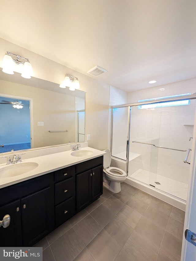 bathroom with visible vents, a sink, double vanity, and a shower stall