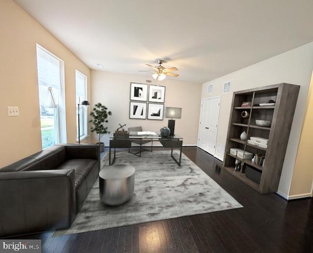 living area featuring a ceiling fan, visible vents, built in features, and hardwood / wood-style flooring